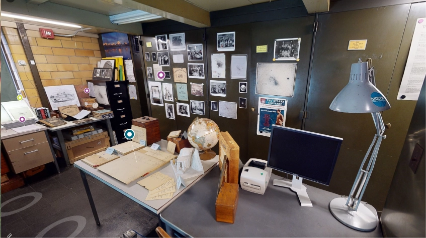 A workbench in front of wall with many photos